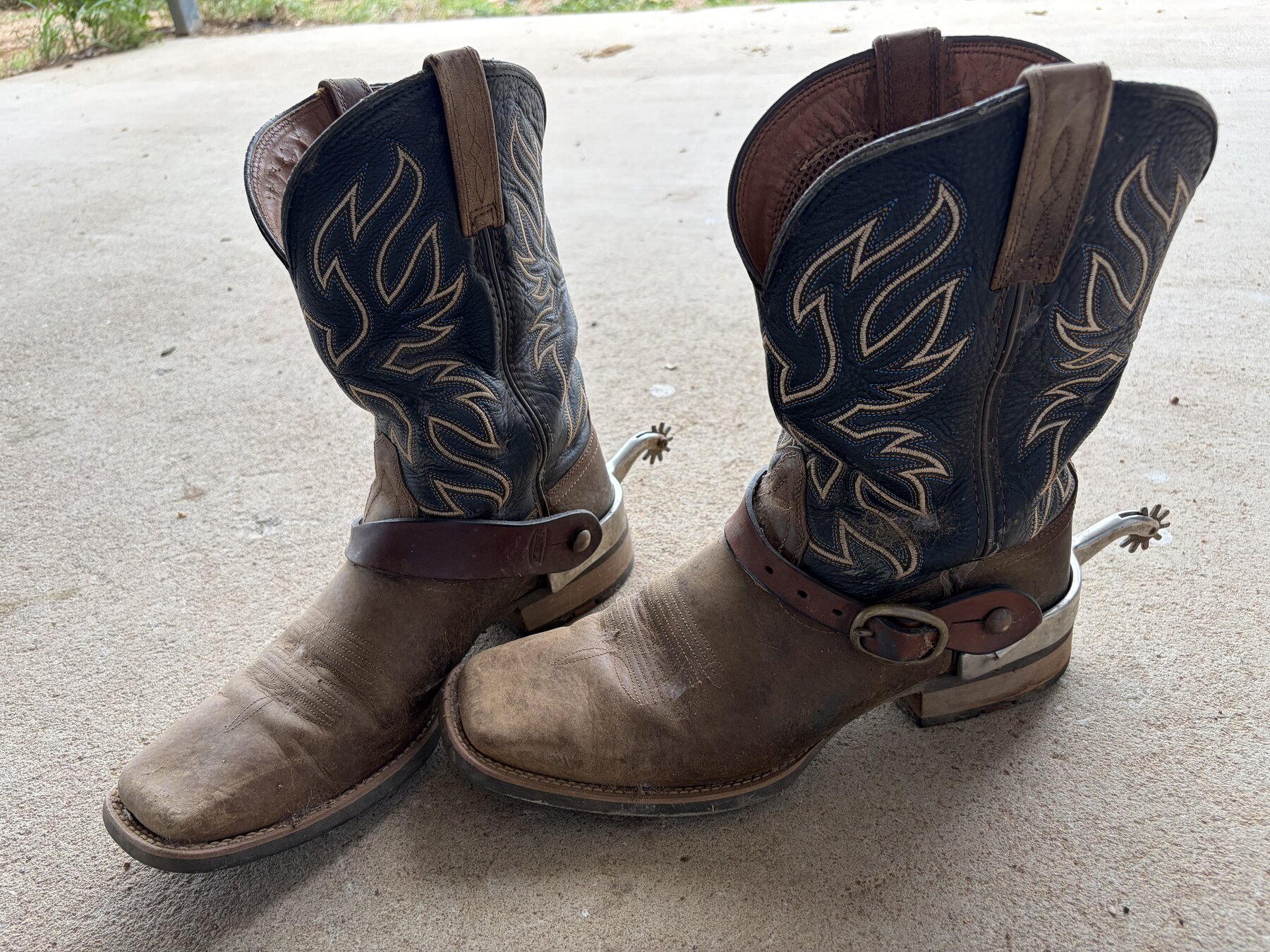 A worn pair of stockman's boots and spurs at the end of the day